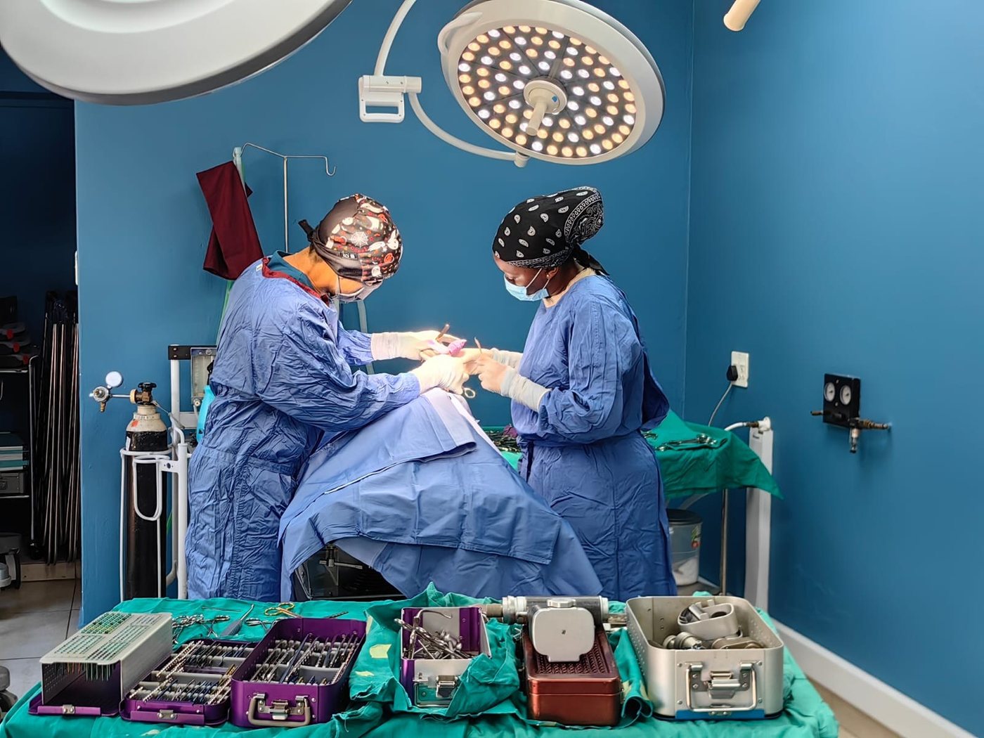 Two of the team operating in theatre
