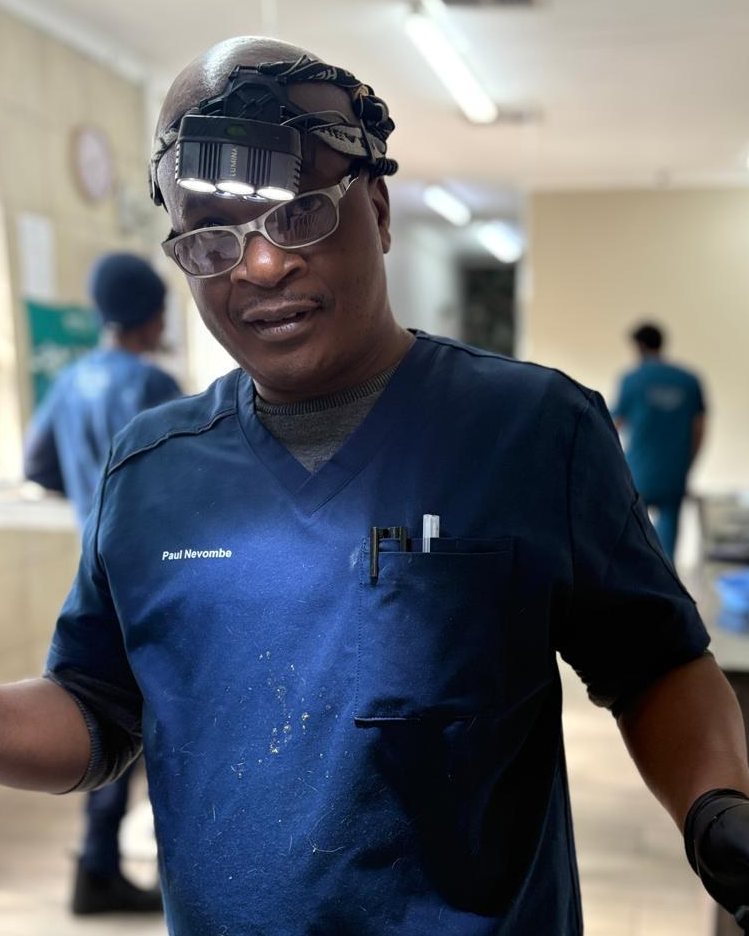 Paul Nevombe, head veterinary assistant, in navy scrubs with a surgical headlamp
